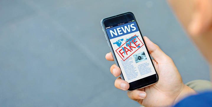 Fake news,Hoax concept.close-up of Hipster man hands holding mobile phones